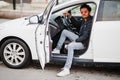 South asian man or indian male wear red eyeglasses sitting inside his white transportation car Royalty Free Stock Photo