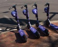 Row of electric scooters on street corner