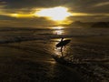 South beach, Sukabumi, West Java, Indonesia : A surfer just finish surfing when sunset time Royalty Free Stock Photo