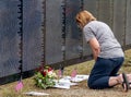 Woman kneels at the wall that heals Royalty Free Stock Photo