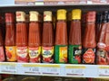 Tomatoes in stacked bottles in a minimarket window