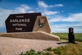 Entering Badlands National Park sign with a Black Labrador Retriever dog posed by the sign