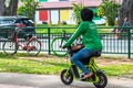 Asian Muslim Malay female with hijab food delivery rider on e-bike scooter