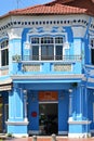 Conserved Straits Chinese corner terrace house, converted into a retail outlet, with distinctive blue color scheme & plaster work