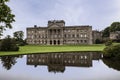 The south front of Lyme Park House with the south lawn a reflection lake.