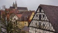 Half timber house and church in background rothenburg Royalty Free Stock Photo