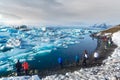 South Iceland - March 12, 2017. Tourist walking along glacier la