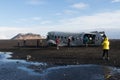 South Iceland Tourist walking to famous landmark the abandoned wreck of a US military plane on Solheimasandur