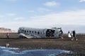 South Iceland Tourist walking to famous landmark the abandoned wreck of a US military plane on Solheimasandur