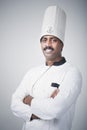 South Indian chef standing with his arms crossed and smiling