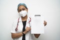 A south Indian female doctor in 30s with with cap mask white coat and red stethoscope