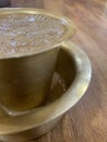 South Indian Filter Coffee in dabarah a wide metal saucer with lipped walls