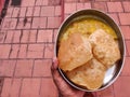 plate filled with poori or puri with potato masala