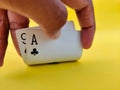 South Indian man raises playing cards to see his cards.