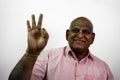 South Indian old baldness man saying super in front of camera and finger out of focus on White Background