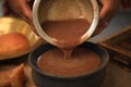 ragi malt, finger millet porridge served in a traditional mud pot served closeup