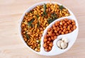 South indian spicy crunchy mix Nimco or Namkeen and spicy coated peanut white bowl wooden background isolated