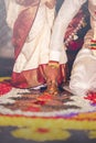 South Indian wedding ritual Saptapadi. Groom holding brides foot during marriage