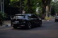 black BMW iX xDrive40 electric car driving fast on the road blurry in motion