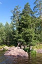 South Karelia lake, Russian wild nature. Stone rock shore of a forest lake. Scandinavian landscape. Russia. Vertical