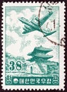 SOUTH KOREA - CIRCA 1954: A stamp printed in South Korea shows Douglas DC-6 over East Gate, Seoul, circa 1954.