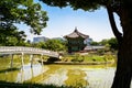 South Korea, Seoul. Gyeongbokgung palace area garden and park. Hyangwonjeong pavilion and bridge. City skyline in the background. Royalty Free Stock Photo