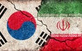 South korea vs Iran Economical or Political conflict. Grunge country flag illustration cracked concrete background