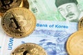 South Korea Won banknotes and Bitcoin Cryptocurrency coins close up image.