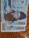 South korean Won 1000 and coin on table