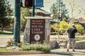 South Lake Tahoe USA - Sign Welcome to South Lake Tahloe California on stree corner with man in shorts on phone walking