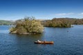 Tourists rowing boat on scenic Lake Windermere in Lake District National Park, North West England, UK