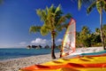 South Pacific island scene with colorful kayaks on the beach. Royalty Free Stock Photo