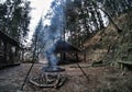 South Poland: Barbecue location in the middle of the forest surrounded with tall trees. Wilderness wide angle view of smoke coming