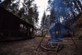 South Poland: Barbecue location in the middle of the forest surrounded with trees. Wilderness wide angle view of smoke coming from