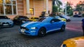 Blue Ford Mustang Ecoboost driving fast on parking lot blurry in motion Royalty Free Stock Photo