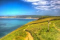 South west coast path towards Woolacombe Devon England UK in summer with blue sky in hdr Royalty Free Stock Photo