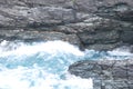 Waves crashing into the rocks at Tintagel Castle in Cornwall, South West England, UK Royalty Free Stock Photo