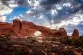 South window arch with the first sunrays of the day behind in the Arches National Park, Utah