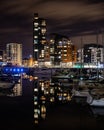 Ocean Village marina at night reflecting on calm waters with yachts docked at a jetty Royalty Free Stock Photo