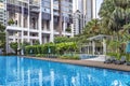 Modern high-rise residential apartment with a beautiful tropical garden and swimming pool Royalty Free Stock Photo