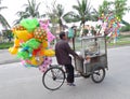 Southeast Asia Vietnam Hoi An Street Hawker on Bicycle Bike motor bike Porter Goods Circus Toys Balloons Fun Joyful Freeride Rider