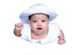 Southeast Asian baby girl is wearing white hat and shirt. South East Asian newborn is 4 months old. New born is concentrate. Royalty Free Stock Photo