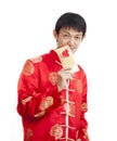 Southeast Asian male in cheongsam hands holding red packets ,ang pow , isolated on white background. Royalty Free Stock Photo