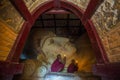 Southeast Asian neophytes light candles inside a Buddhist temple