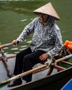 Southeast Asian woman paddling a boat to Thien Tru Temple and the Perfume Pagoda in Hanoi, Vietnam Royalty Free Stock Photo