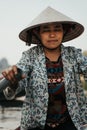 Southeast Asian woman paddling a boat to Thien Tru Temple and the Perfume Pagoda in Hanoi, Vietnam Royalty Free Stock Photo