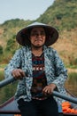 Southeast Asian woman paddling a boat to Thien Tru Temple and the Perfume Pagoda in Hanoi, Vietnam Royalty Free Stock Photo