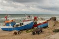 Souther Baltic sea coast, Northern Poland, Pomerania, sandy beach, dramatic sky, late winter time, fishing boat on the sand
