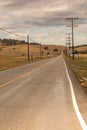 Vanishing viewpoint highway, storm clouds, wet pavement Royalty Free Stock Photo