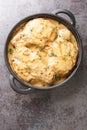 Southern classic comfort food, crispy coated pork chops smothered in a rich onion gravy closeup on the pan. Vertical top view